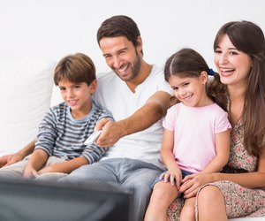 Happy family watching television