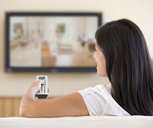 Woman in living room watching television