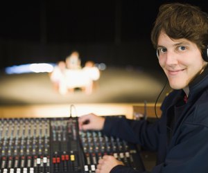 Portrait of a man at a sound mixer in a recording studio