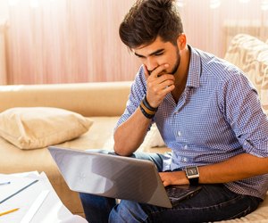 Young male student working at home.
