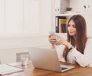 Beautiful young businesswoman making a call by mobile phone