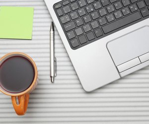 laptop computer on desk with cup of tea
