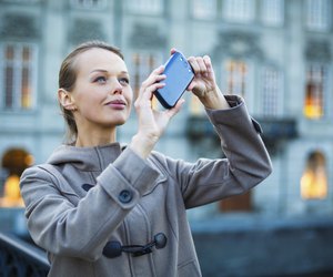 Elegant, young woman taking a photo