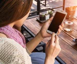 Woman using smartphone in the cafe.