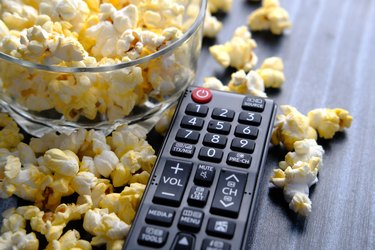 Popcorn in a bowl with tv remote