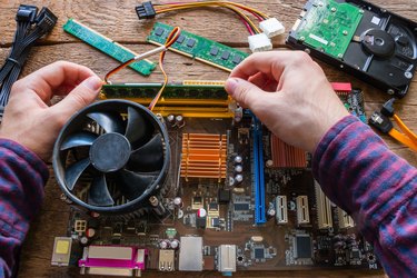 man repairing computer hardware