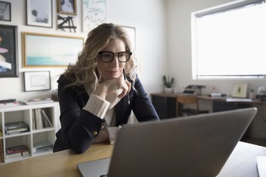 Senior businesswoman entrepreneur working at laptop in studio office