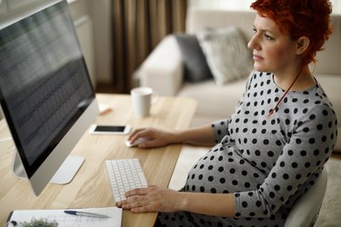 Pregnant woman working from home office
