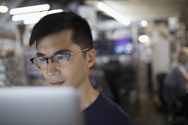 Focused male engineer working at laptop