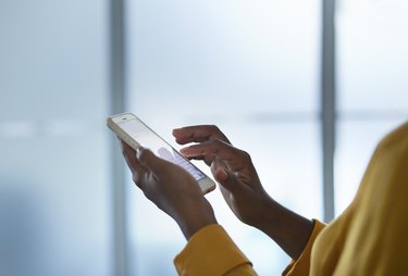 Close-up of businesswomans hands holding phone