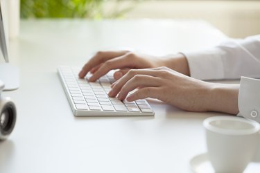 woman hands typing on computer keyboard