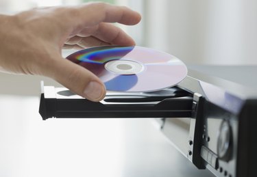 Man inserting dvd