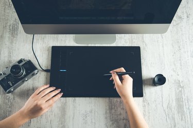 woman hand  tablet pen with computer and camera