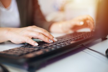 Businesswoman using desktop PC at office