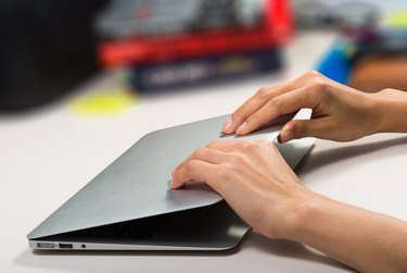 woman closing/opening her laptop