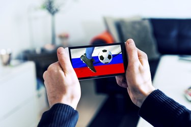 Mobile phone is streaming soccer on smart phone