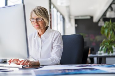 Businesswoman using computer at desk in office