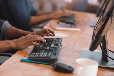 Businesspeople working on computers at an office table