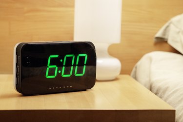 digital clock shows 06.00 am