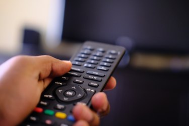 Man hand using tv remote