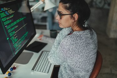 Young woman programming at her home office