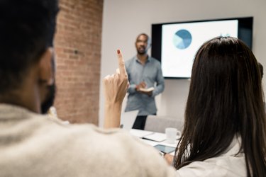 Young man has a presentation with the graph on an LCD screen