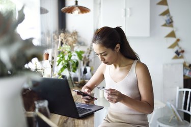 Beautiful woman online shopping in a cafe