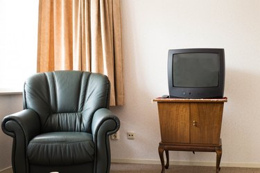 Vintage Television on wooden antique closet, old design in the living room with old chair