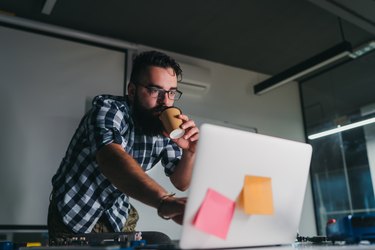 Engineer drinks coffee at work