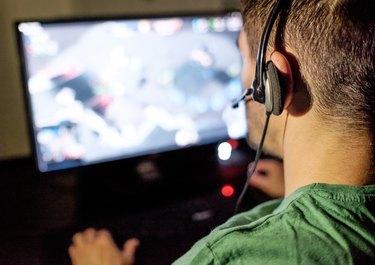 Man playing video game in dark room