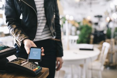 Woman Paying With Smartphone.