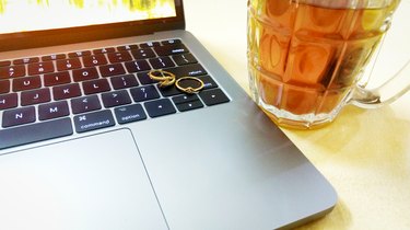 Organic Green Tea in Glass Mug Honey & Tulsi with MacBook Pro Laptop on side and Gold Diamond Rings