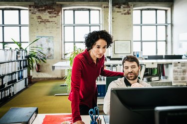 Office Manager Assisting Employee With Problem