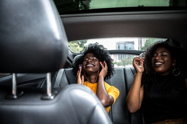 Afro girls having fun in the car