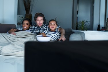 Family having popcorn while watching TV