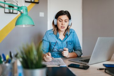 Businesswoman having teleconference call with colleagues