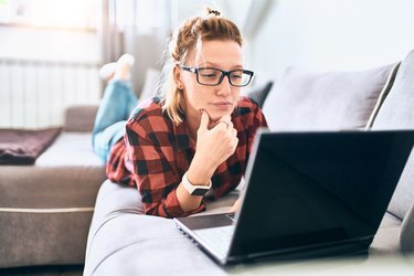 Pretty woman with laptop working at home