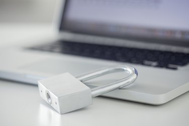 Padlock resting on laptop computer