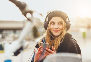 Teenage girl listening music with smartphone