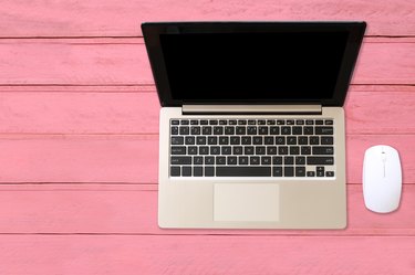 High Angle View Of Laptop On Pink Table