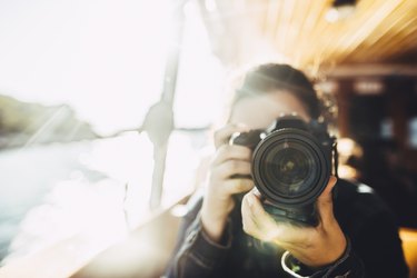 Young woman using a DSLR camera