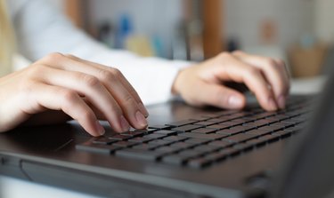 Female worker typing on the keyboard. Distance learning, education online. Online working from home, business and technology concept. Lockdown.