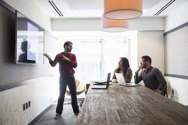 Businessman talking to colleagues in office meeting