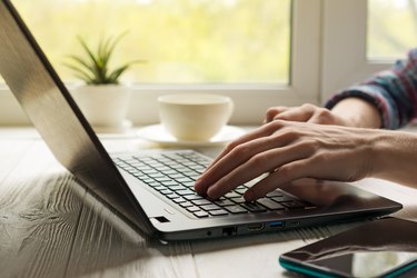 Hands typing on a keyboard