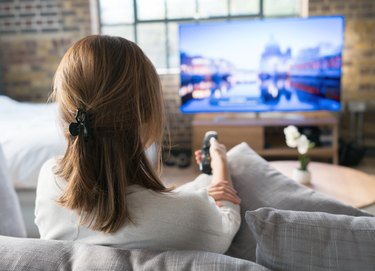 Woman watching tv at home