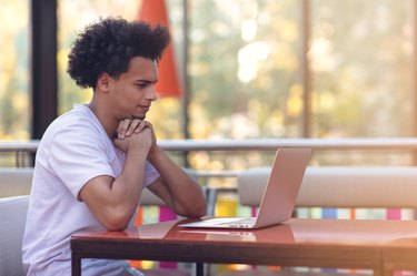 Image of african american businessman working on his laptop. Handsome young man at his desk.