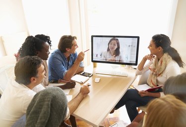People talking on video conference in office