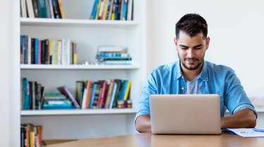 Mexican hipster man working with computer