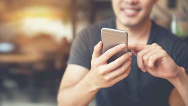 Happy man using smartphone and copy space