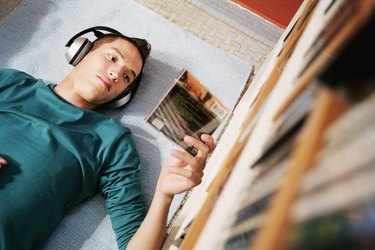 Young Man Reading CD Case